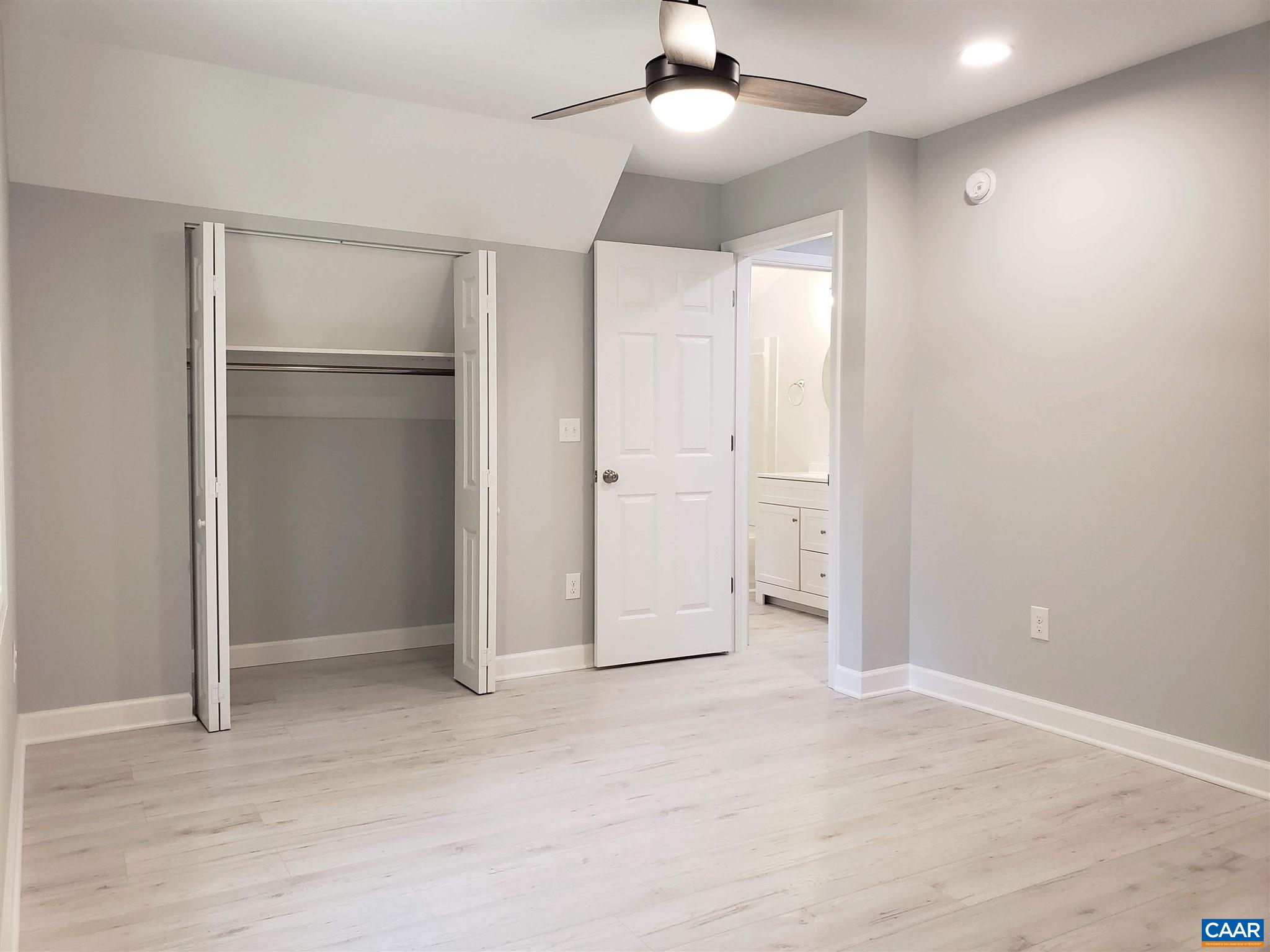 699 Black Cat Road Keswick, VA 22947 - Photo 26 of 33 wooden floor in an empty room with a bathroom