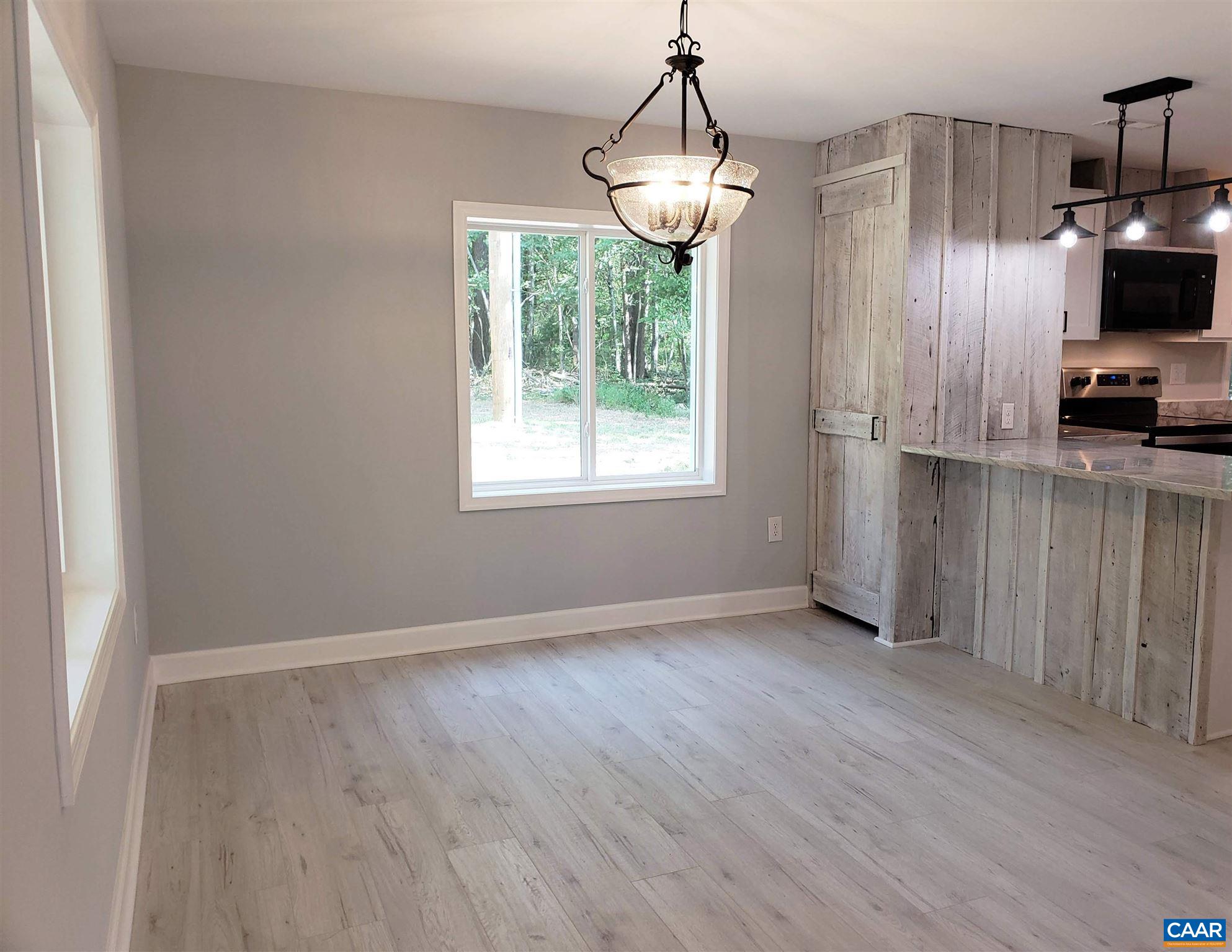 699 Black Cat Road Keswick, VA 22947 - Photo 6 of 33 a view of a kitchen with wooden floor electric appliances and windows