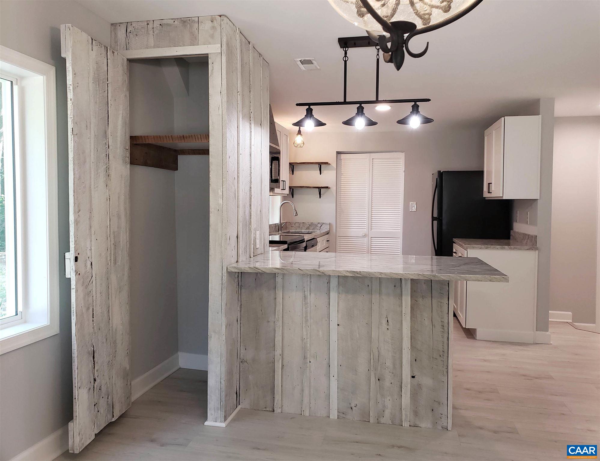 699 Black Cat Road Keswick, VA 22947 - Photo 7 of 33 a kitchen with a refrigerator and microwave