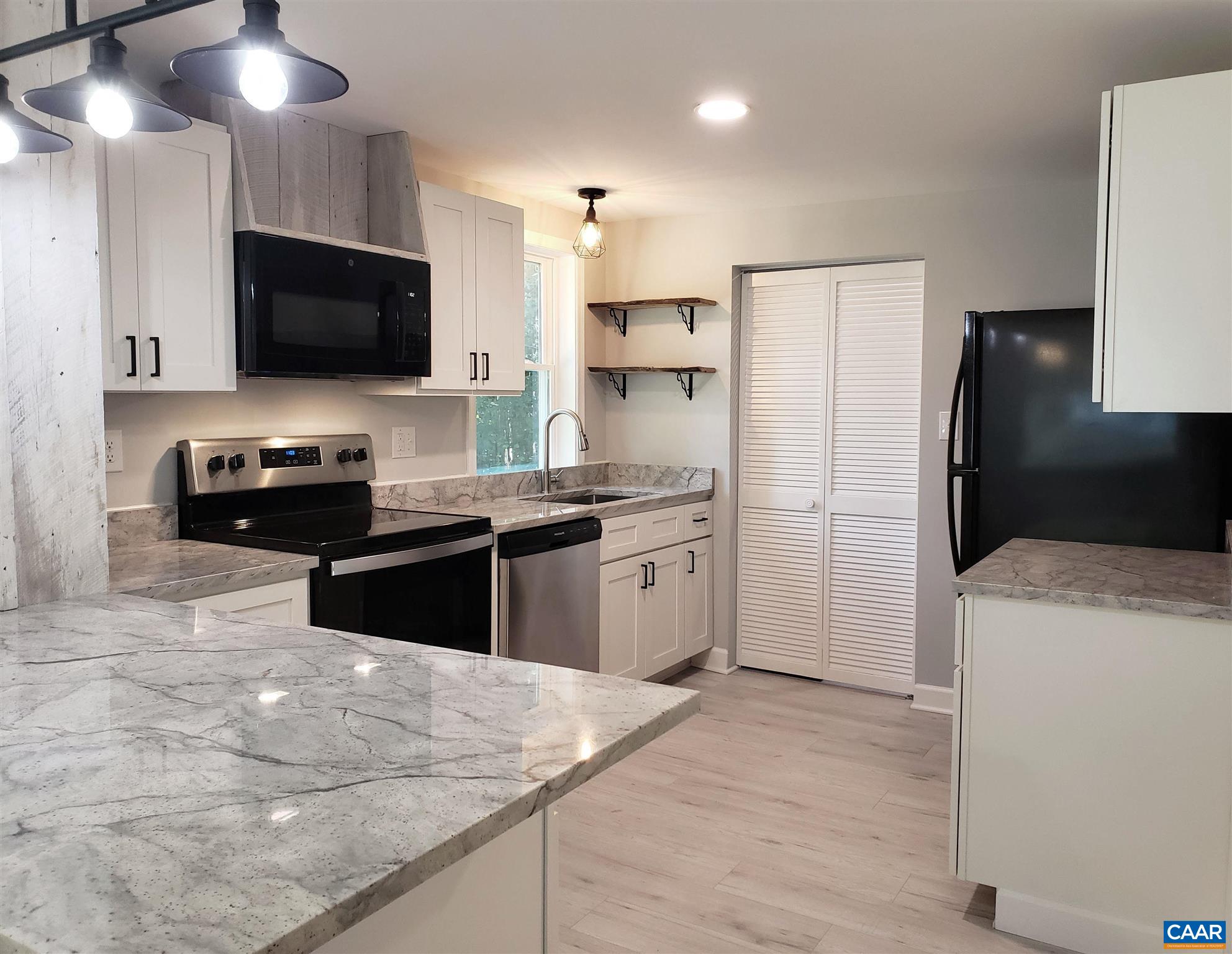 699 Black Cat Road Keswick, VA 22947 - Photo 9 of 33 a kitchen with a sink a stove and refrigerator