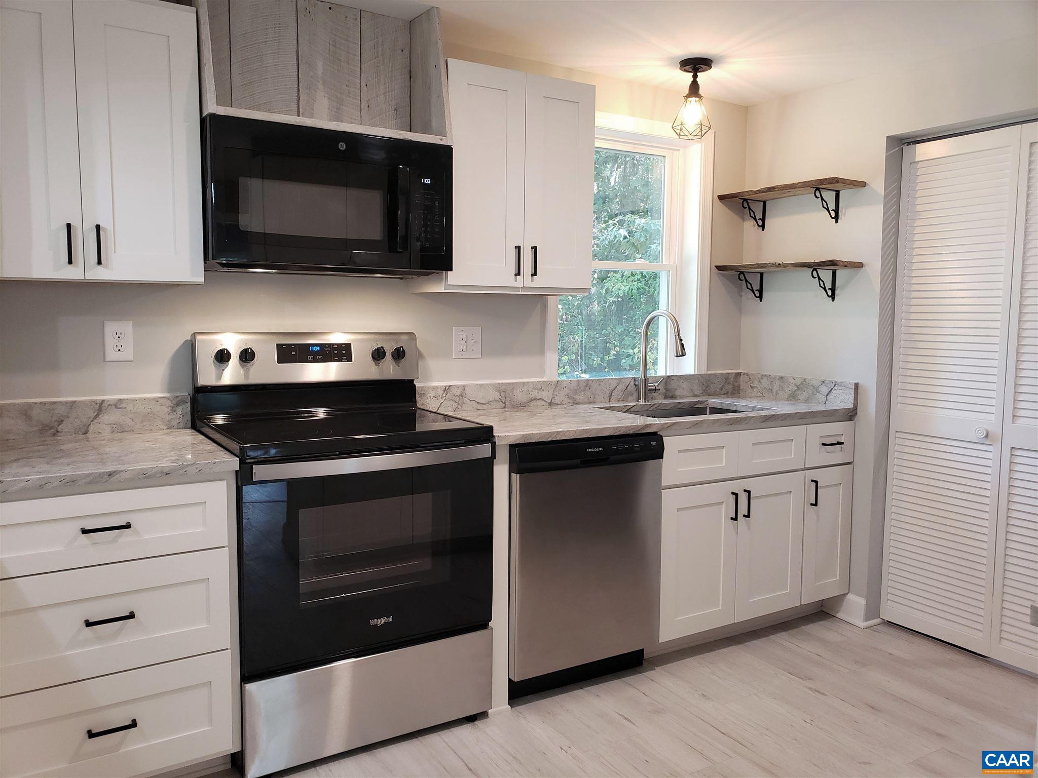 699 Black Cat Road Keswick, VA 22947 - Photo 10 of 33 a kitchen with stainless steel appliances granite countertop a stove a microwave and a sink