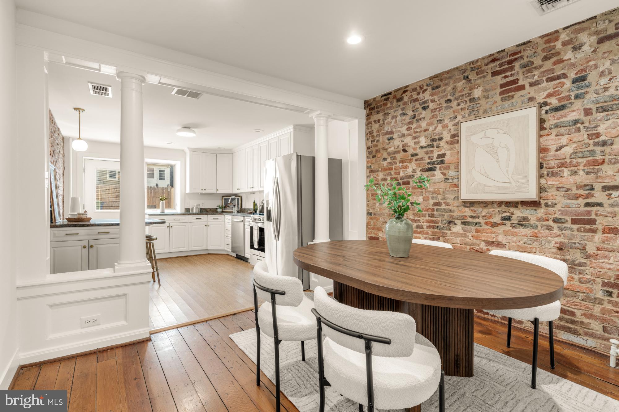 1213 Battery Avenue Baltimore, MD 21230 - Photo 12 of 39 a kitchen with stainless steel appliances kitchen island granite countertop a table chairs and a refrigerator