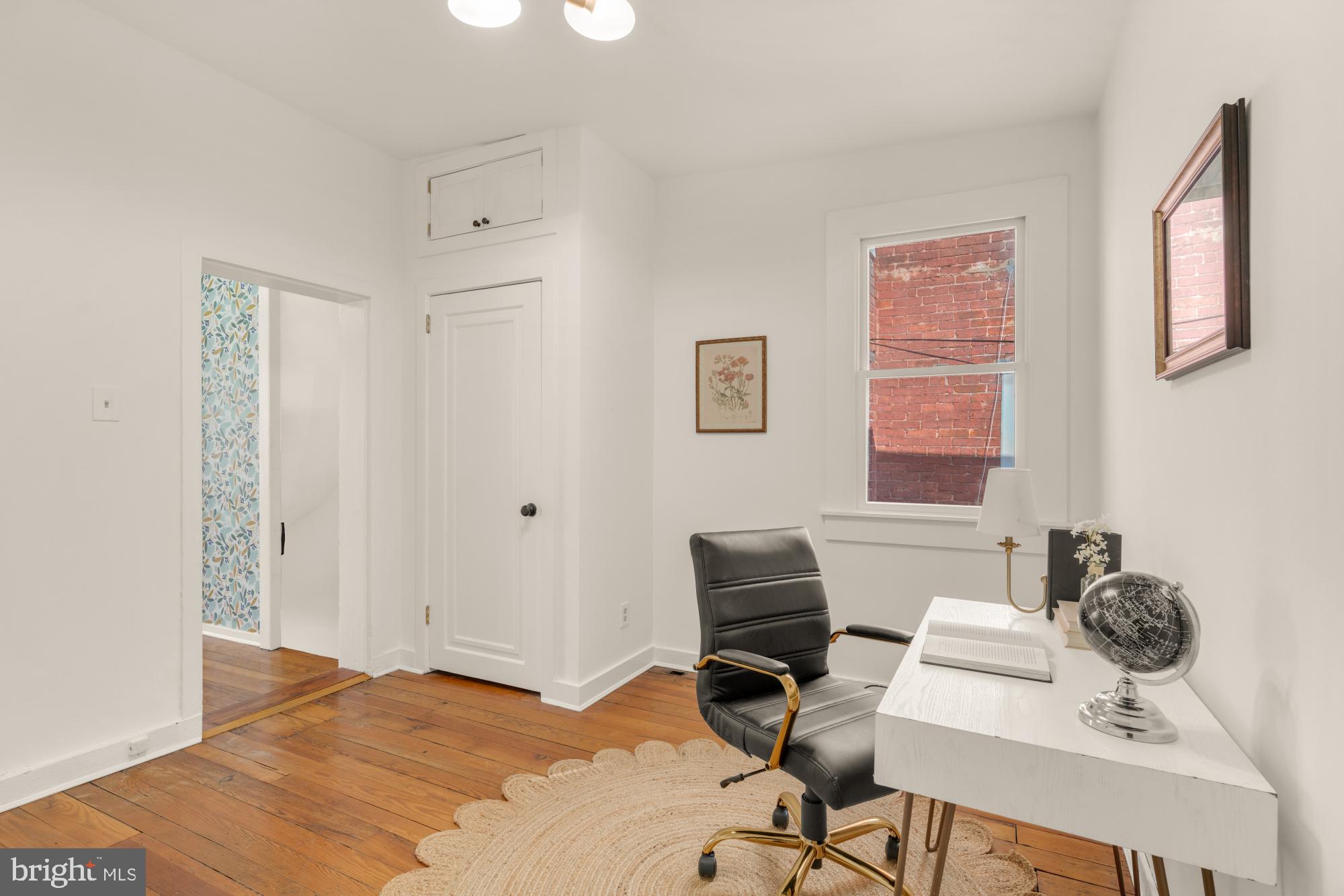 1213 Battery Avenue Baltimore, MD 21230 - Photo 19 of 39 a view of a workspace with furniture and a window