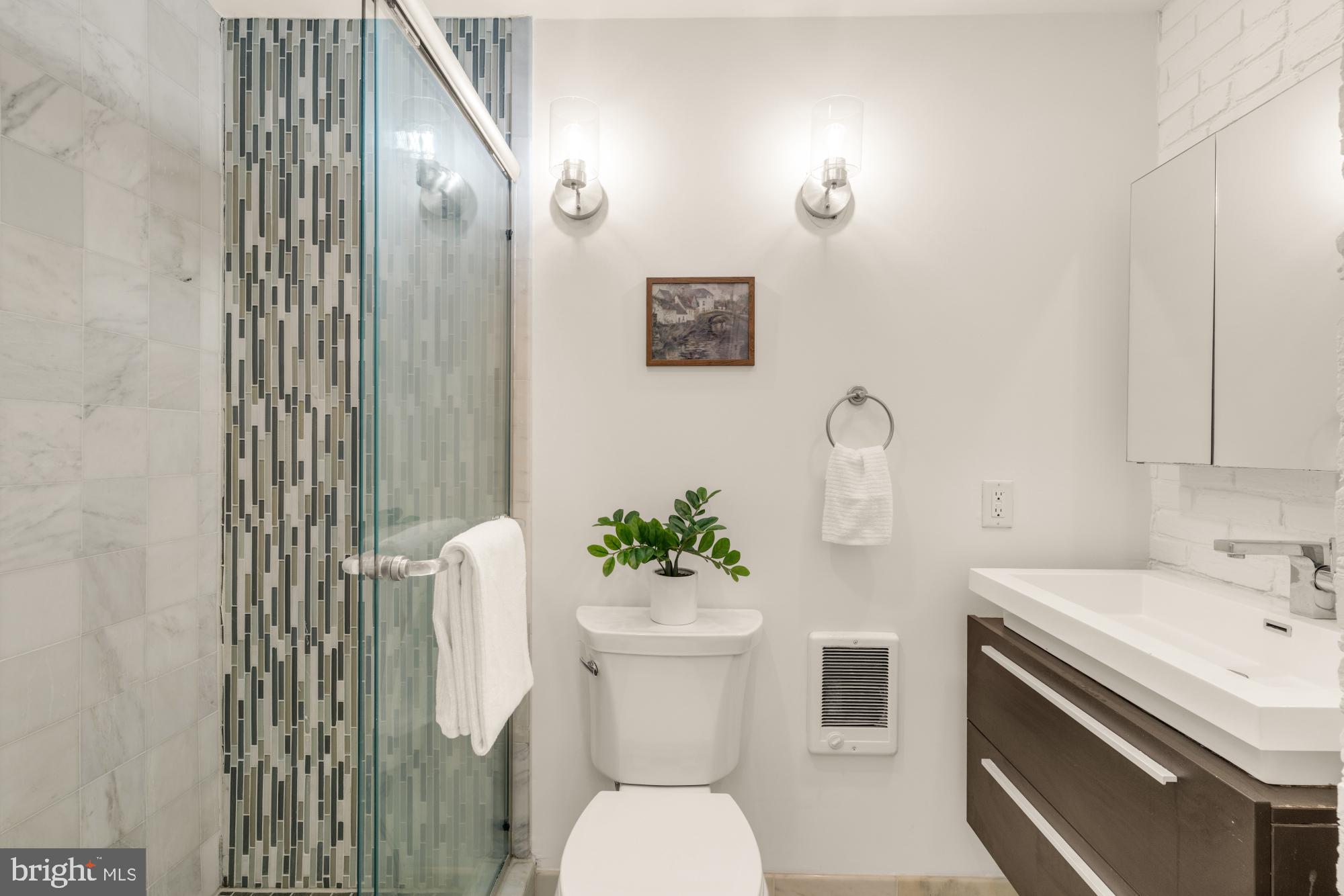 1213 Battery Avenue Baltimore, MD 21230 - Photo 25 of 39 a bathroom with a sink mirror and toilet