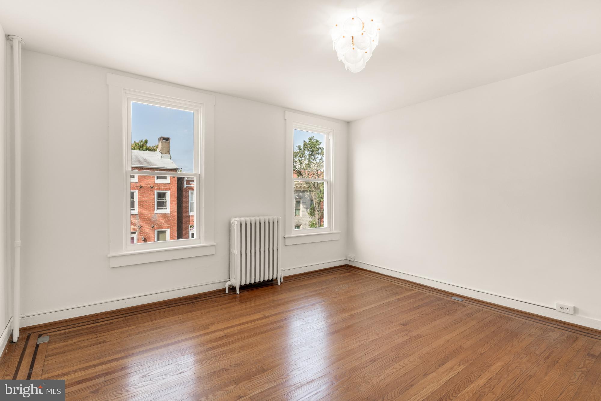 1213 Battery Avenue Baltimore, MD 21230 - Photo 26 of 39 a view of an empty room with wooden floor and a window