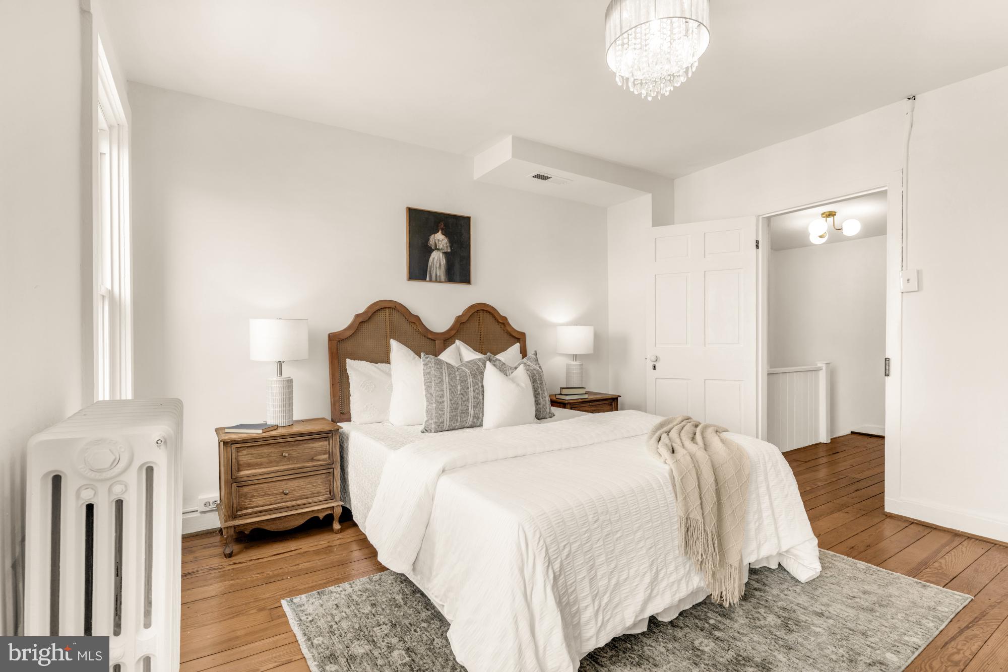 1213 Battery Avenue Baltimore, MD 21230 - Photo 30 of 39 a bedroom with a bed and a chandelier