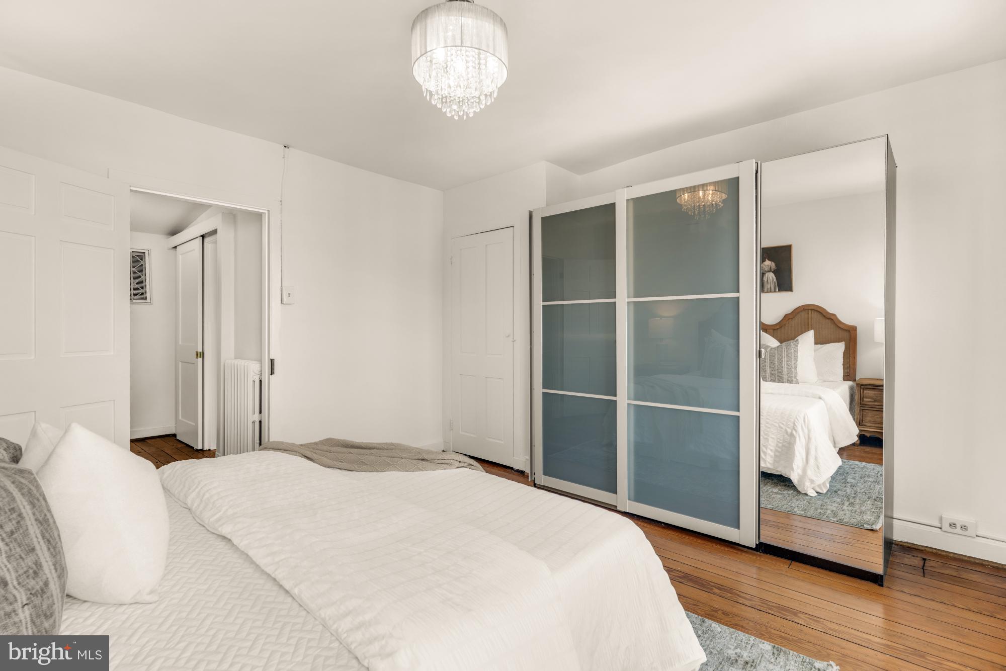 1213 Battery Avenue Baltimore, MD 21230 - Photo 31 of 39 a bedroom with a bed and wooden floor