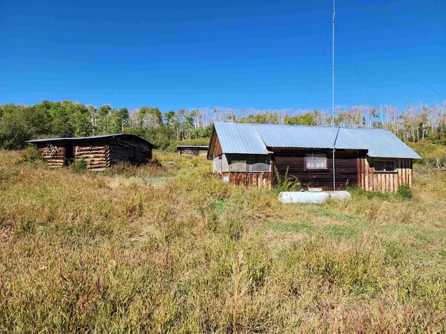 a view of a house with a yard balcony and sitting area