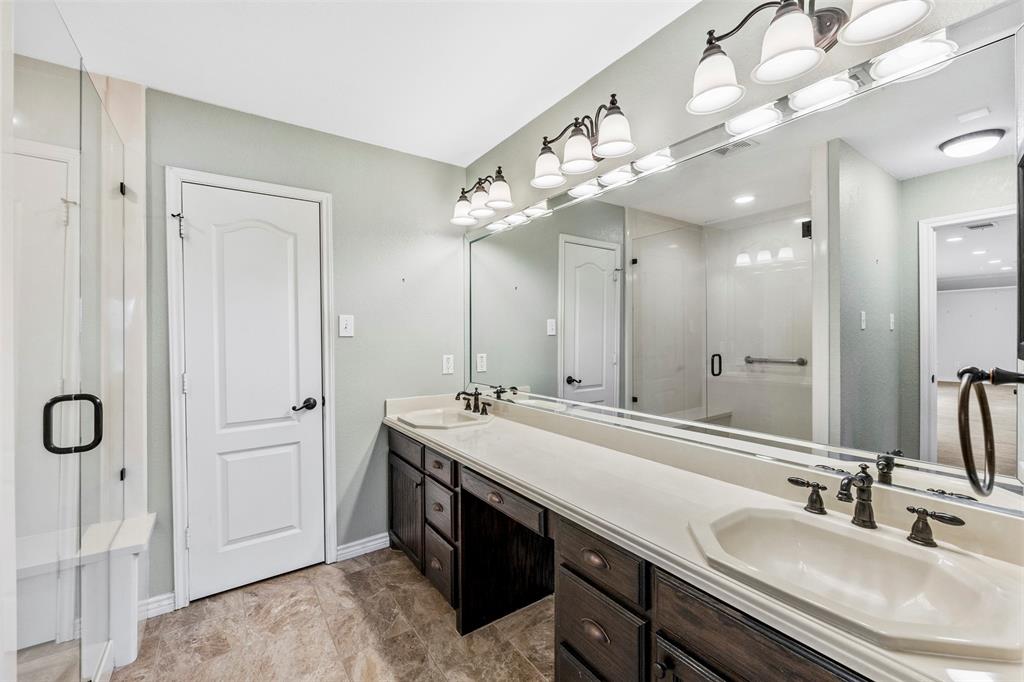3931 Alpha Way Midlothian, TX 76065 - Photo 18 of 33 a bathroom with a double vanity sink a mirror and shower