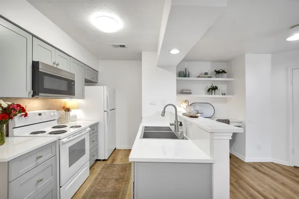 a kitchen with kitchen island a sink stove and refrigerator