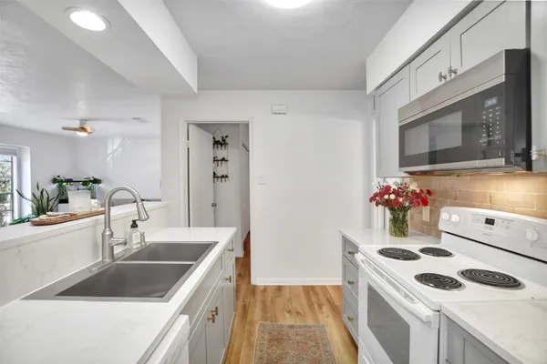 a kitchen with a stove a sink and a microwave