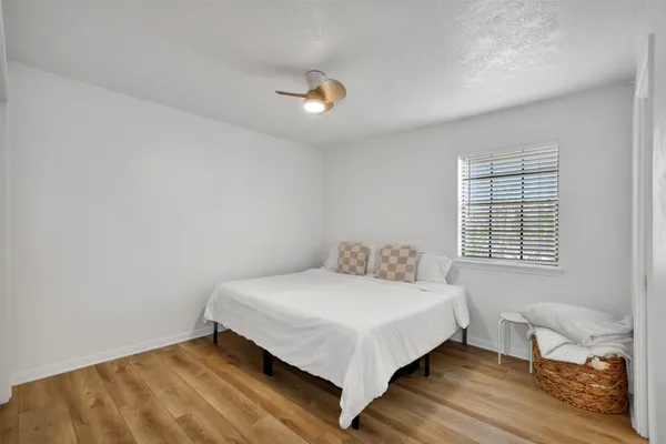 a bedroom with a bed and a window