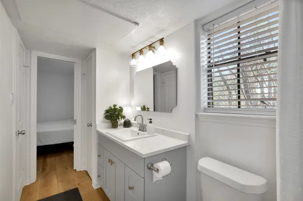 a bathroom with a sink a toilet and tub