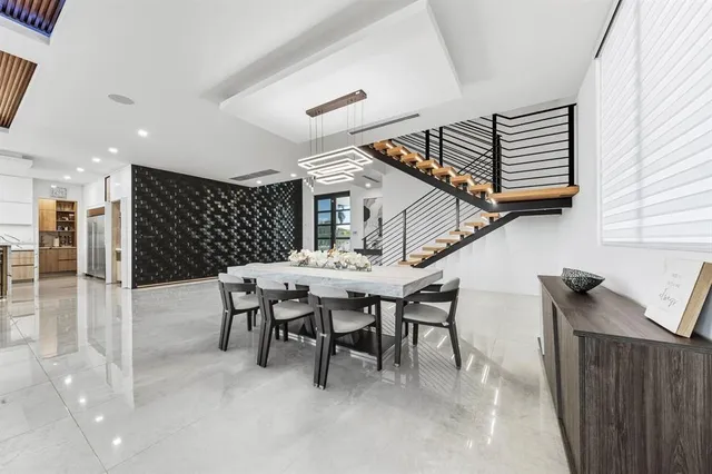 a kitchen with stainless steel appliances kitchen island granite countertop a stove a sink and a refrigerator