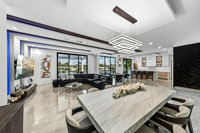 a kitchen with stainless steel appliances kitchen island granite countertop a stove and a sink