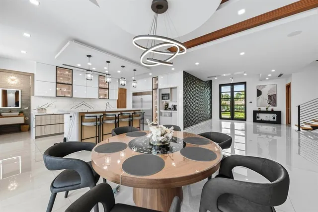 a spacious bedroom with a large bed and a chandelier