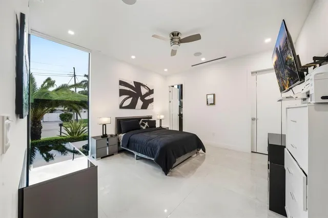 a living room with furniture and a floor to ceiling window