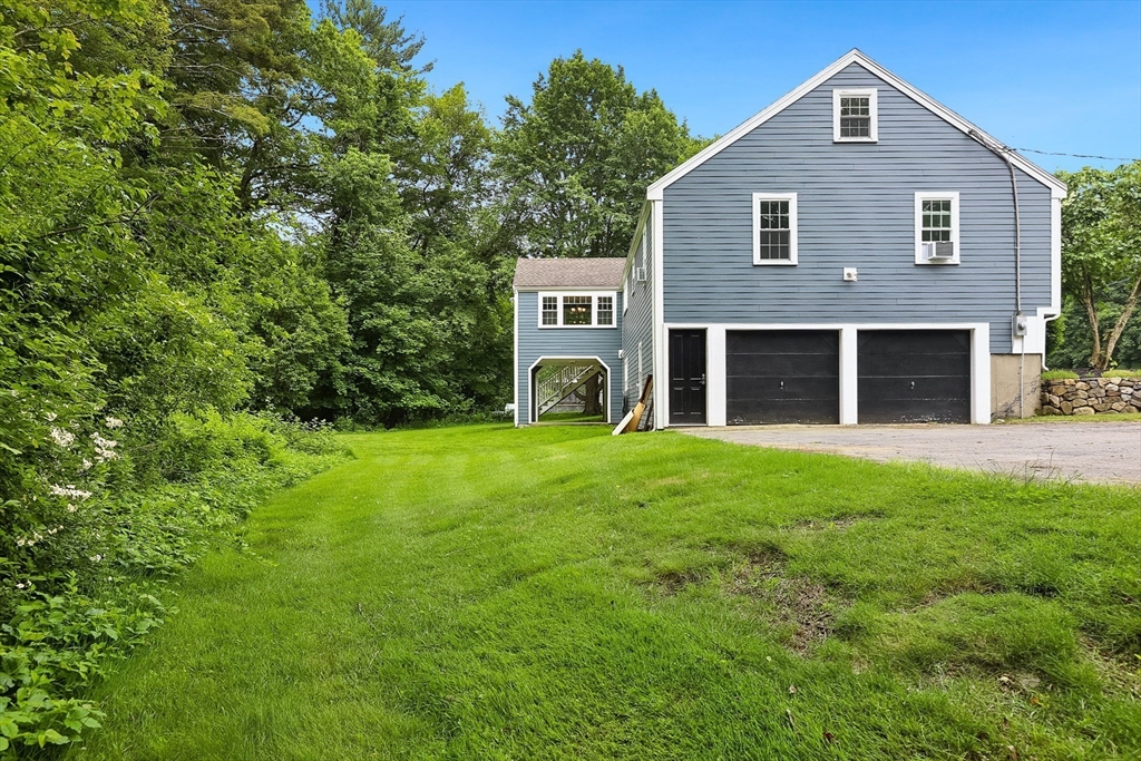 5 Fox Run Road Topsfield, MA 01983 - Photo 22 of 23 a front view of a house with garden and porch