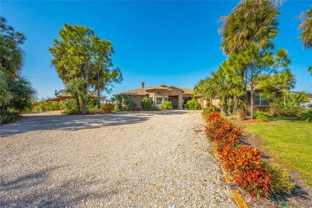 a view of a livingroom with furniture wooden floor chandelier and windows