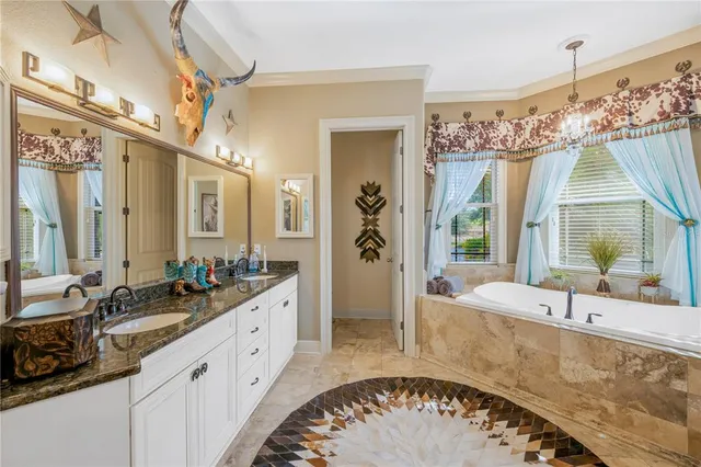 a view of a swimming pool with lawn chairs under an umbrella