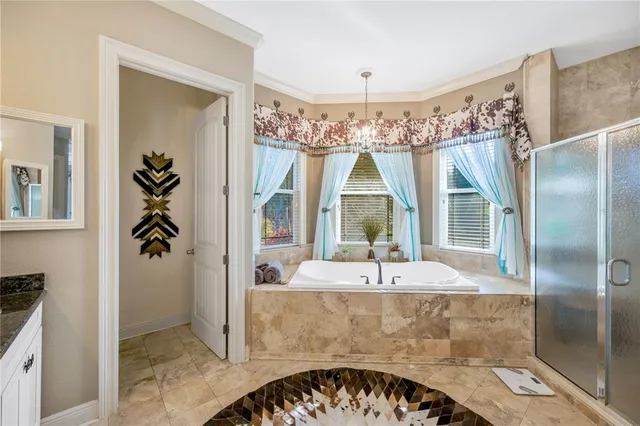 a view of a swimming pool with a lawn chairs under an umbrella