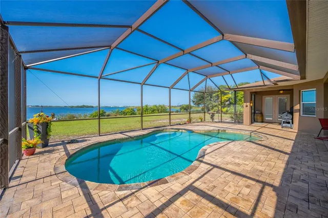 a front view of a house with a yard and potted plants