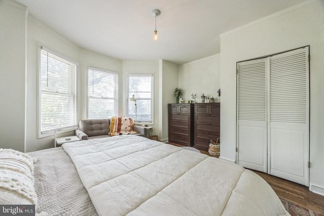 a bedroom with a large bed and a dresser