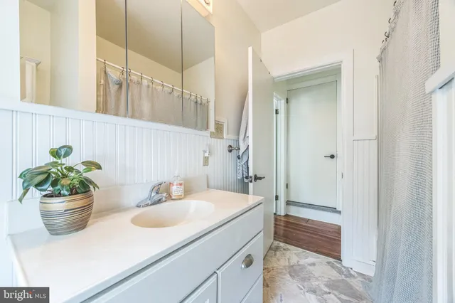 a bathroom with a sink a toilet and a mirror