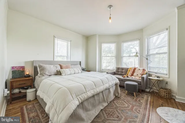 a bedroom with a bed and a couch