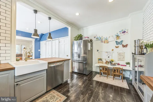 a kitchen with a sink appliances and cabinets