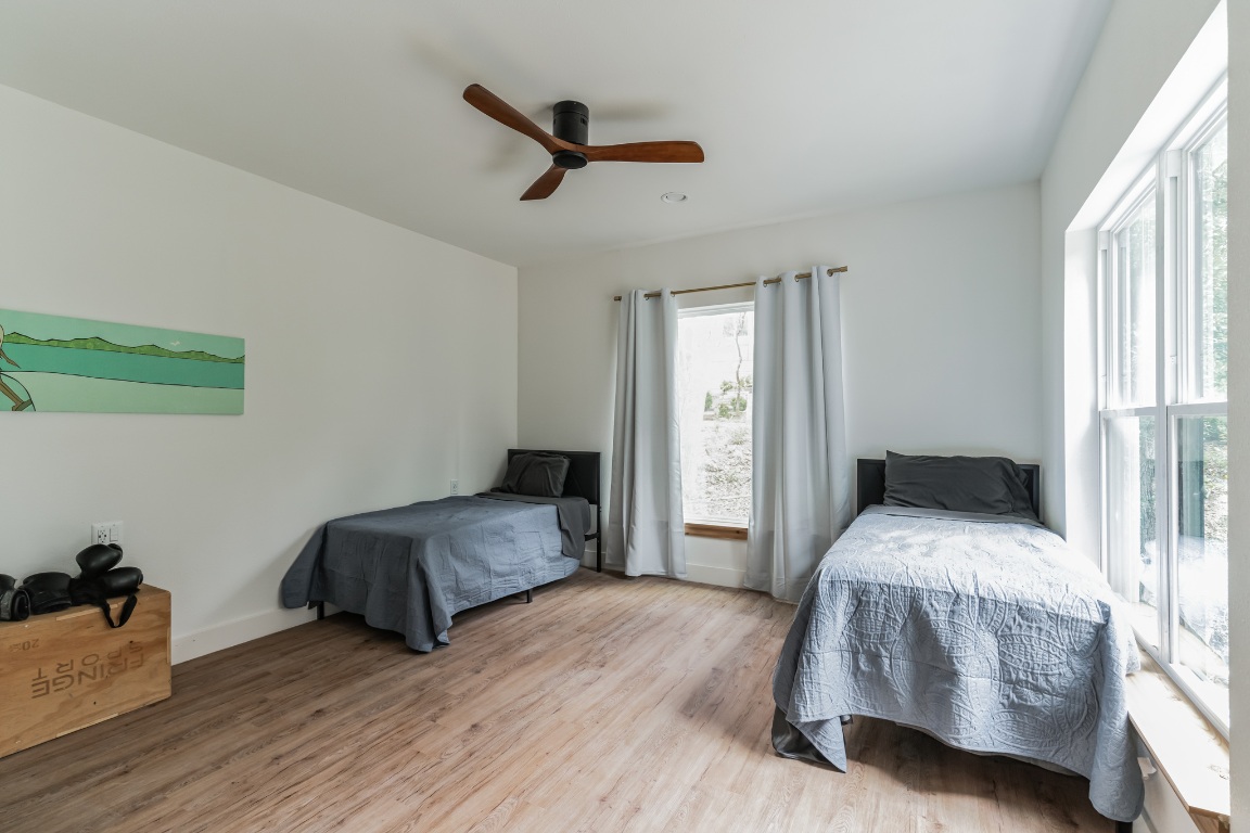 107 Blue Ridge Trail Austin, TX 78746 - Photo 19 of 38 Bedroom with wood finished floors and a ceiling fan