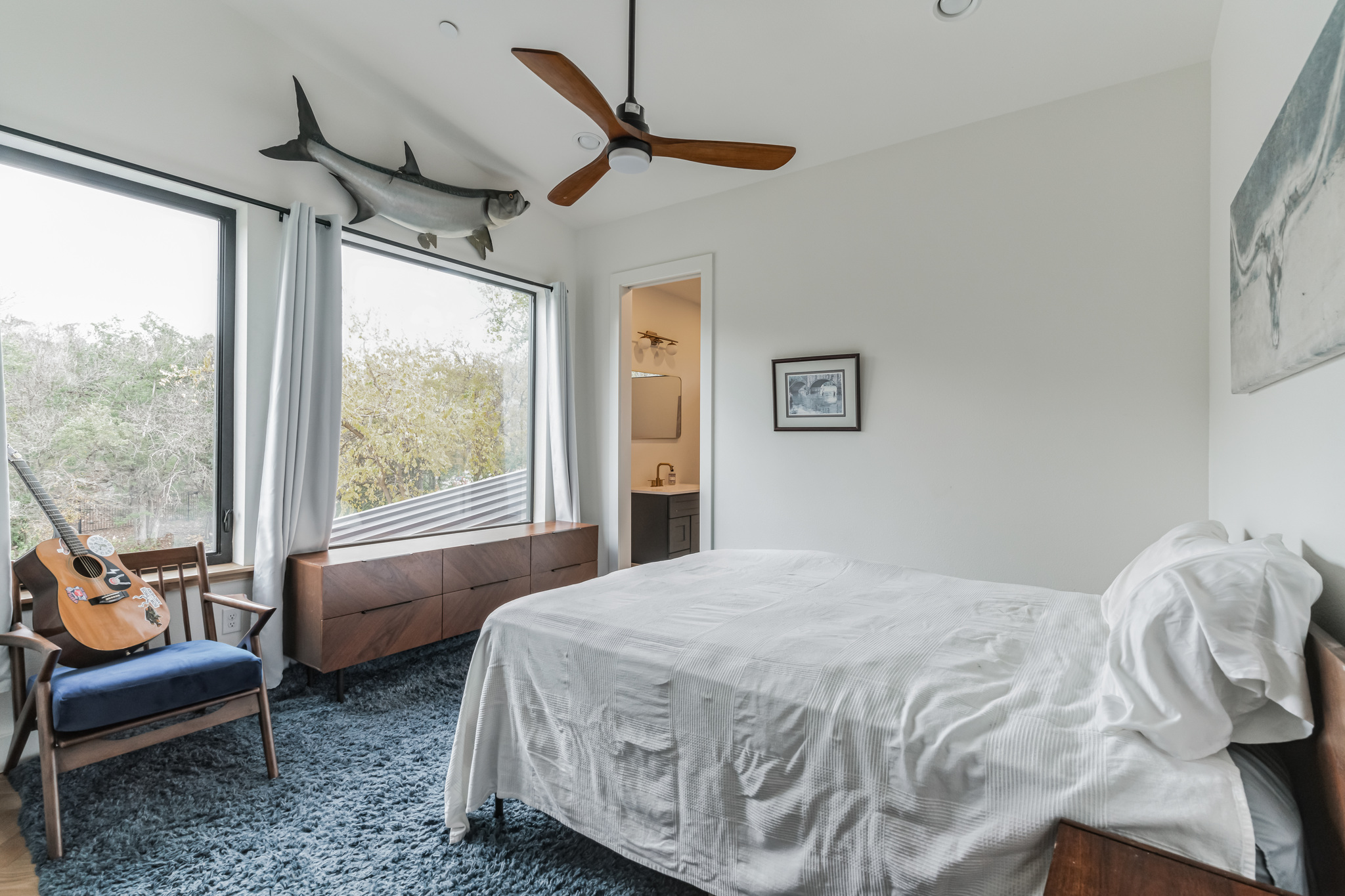 107 Blue Ridge Trail Austin, TX 78746 - Photo 24 of 29 a bedroom with furniture and a large window