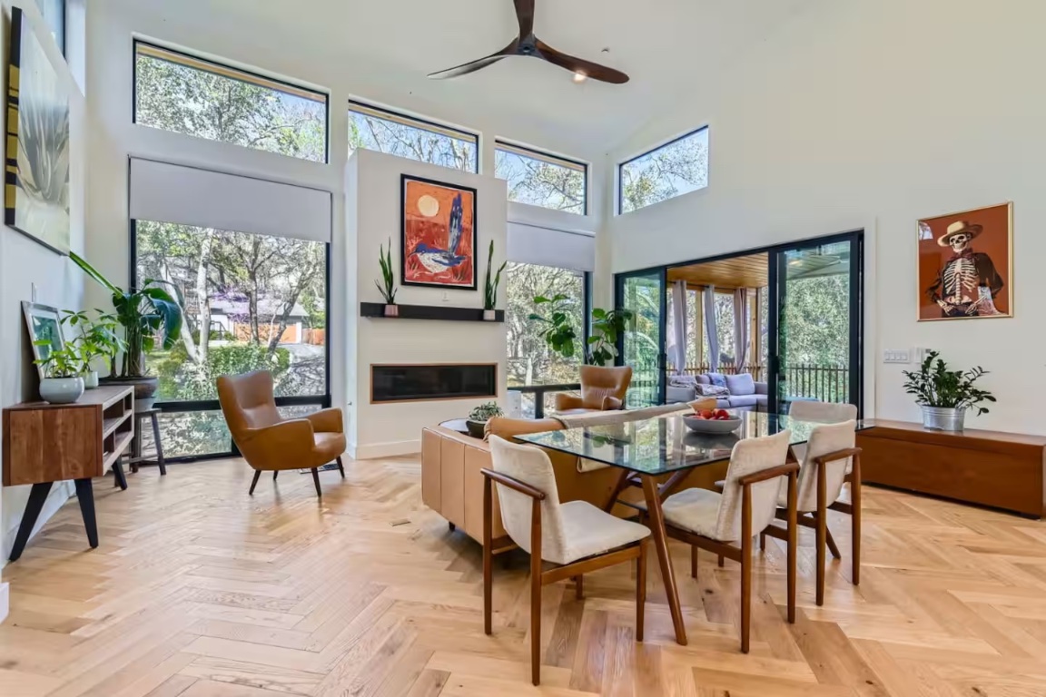 107 Blue Ridge Trail Austin, TX 78746 - Photo 4 of 38 Dining room with a glass covered fireplace, a high ceiling, and ceiling fan