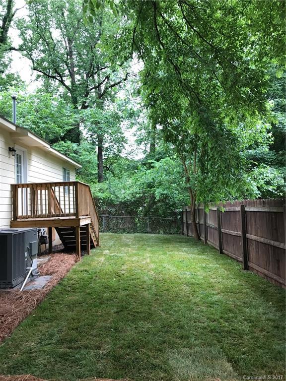 4200 Raney Way Charlotte, NC 28205 - Photo 11 of 12 a view of a yard with a small deck and a large tree