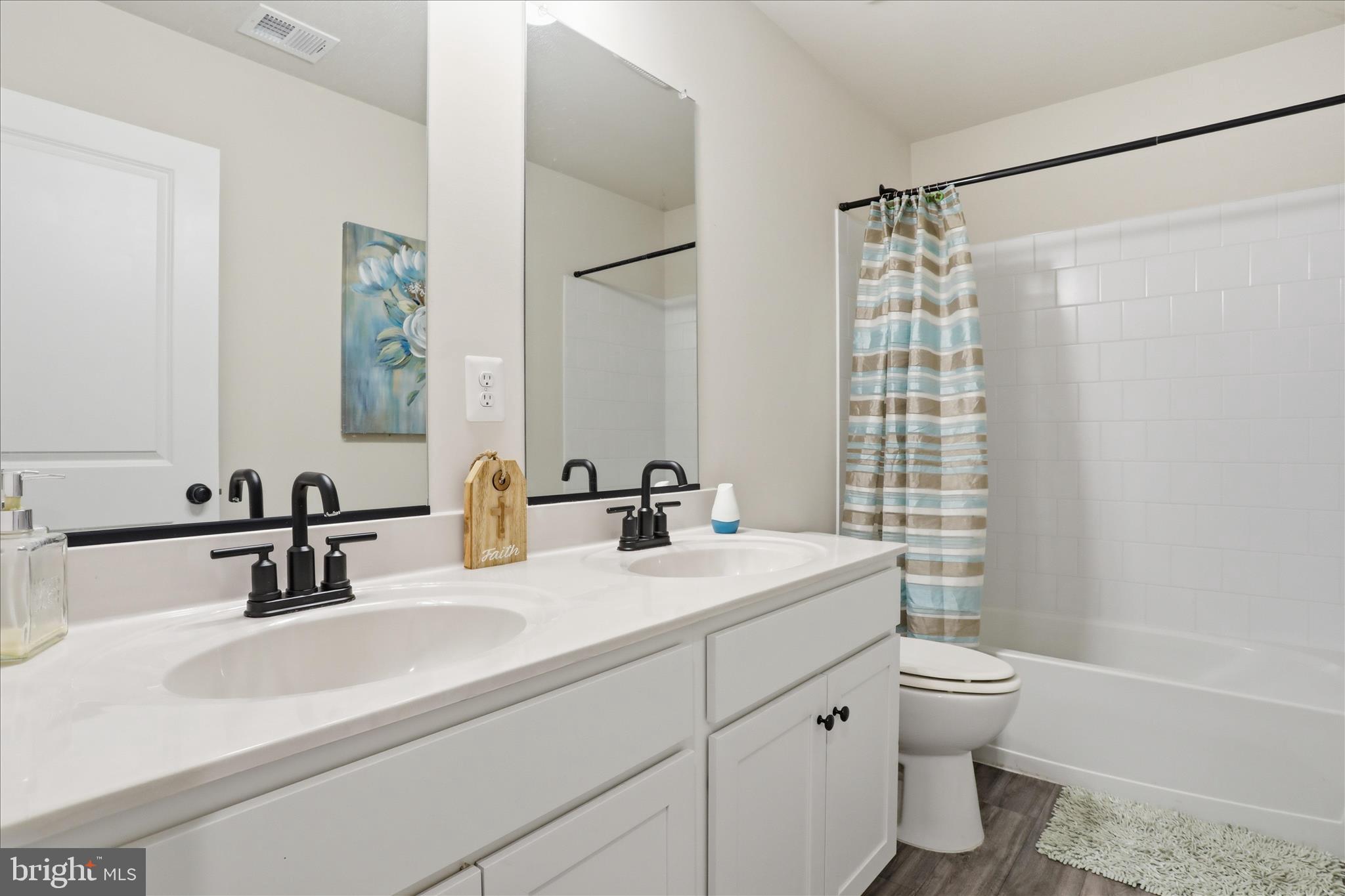 76 Diving Scaup Road Hedgesville, WV 25427 - Photo 27 of 48 a bathroom with a double vanity sink toilet and shower
