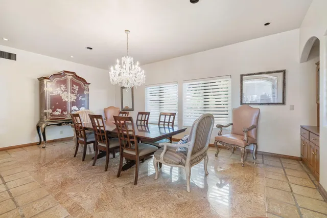 a spacious bathroom with a tub a sink and a large mirror next to a window