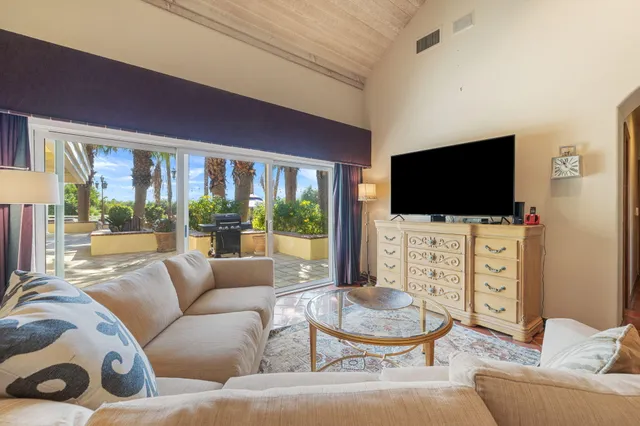 a view of a patio with a dining table and chairs