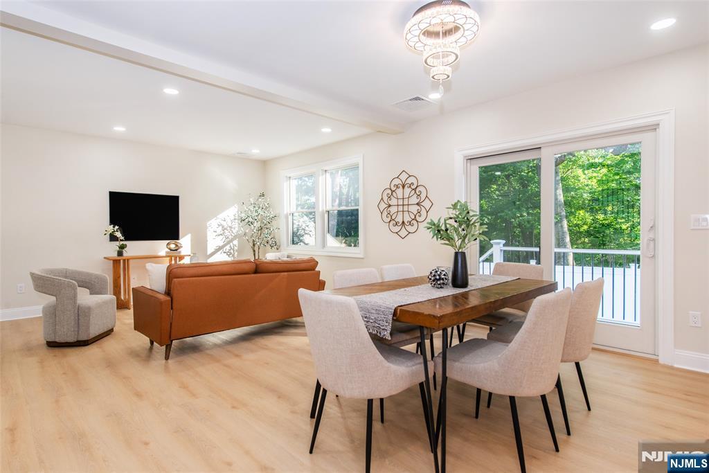 145 Grove Street Mahwah, NJ 07430 - Photo 5 of 30 a dining room with furniture a flat screen tv and a chandelier