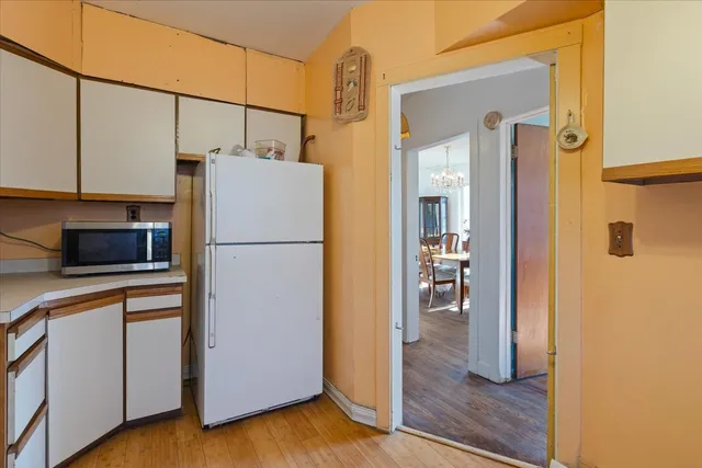 a kitchen with a refrigerator a stove and a microwave