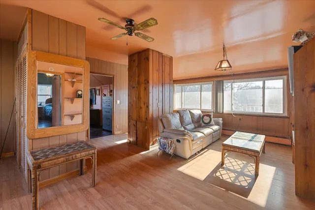 a living room with furniture a rug and a window