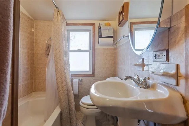 a bedroom with a bed and a view of closet