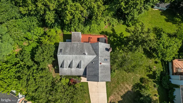an aerial view of a house with swimming pool and garden