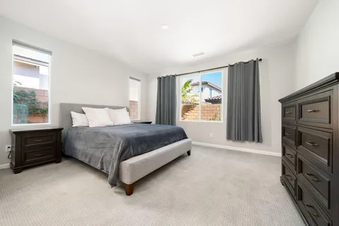 a bedroom with a bed and a tv on the dresser