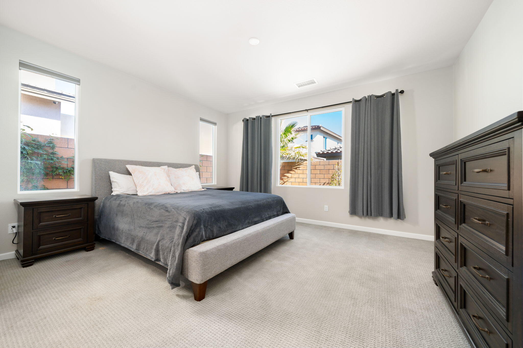 74338 Millennia Way Palm Desert, CA 92211 - Photo 16 of 33 a bedroom with a bed and a tv on the dresser