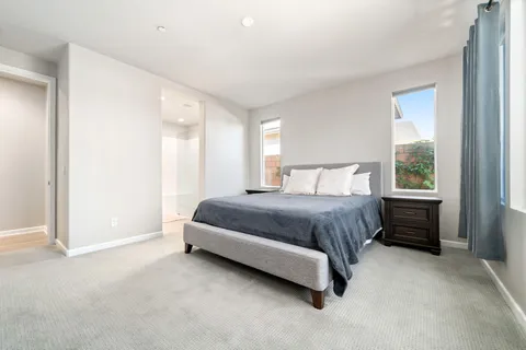 a spacious bedroom with a bed and a window