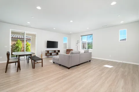 a living room with furniture wooden floor and a flat screen tv