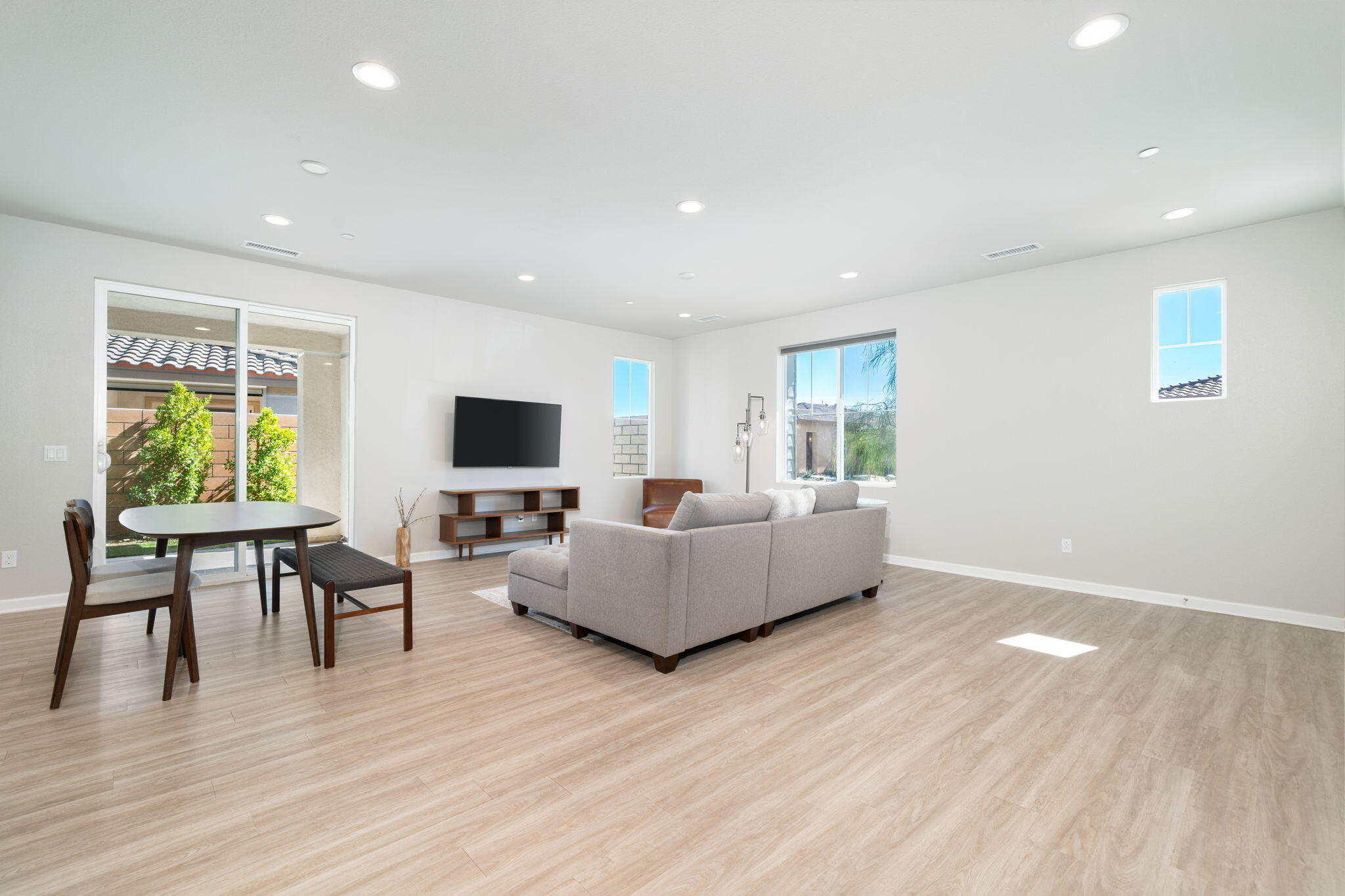 74338 Millennia Way Palm Desert, CA 92211 - Photo 7 of 33 a living room with furniture wooden floor and a flat screen tv