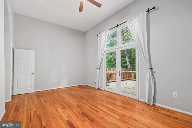 a room with a bed and wooden floor