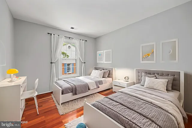 a bedroom with two beds and a window