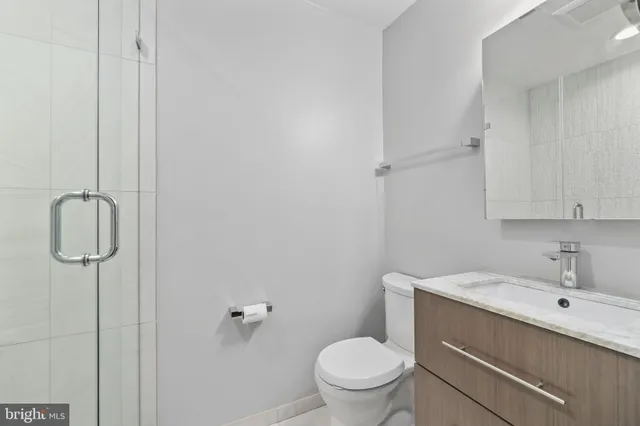 a bathroom with a shower toilet and sink